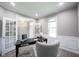 Comfortable home office with wainscoting, french doors, and lots of natural light at 12600 Misty Ridge Ct, Fishers, IN 46037