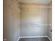 Organized walk-in closet featuring white wire shelving for ample storage and gray carpet at 12600 Misty Ridge Ct, Fishers, IN 46037