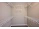 Bright walk-in closet with white wire shelving, neutral walls, and carpet flooring at 12600 Misty Ridge Ct, Fishers, IN 46037