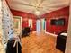 Bedroom featuring bold red walls, hardwood floors, and bright overhead lighting at 1332 W 26Th St, Indianapolis, IN 46208