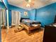 Cozy bedroom with hardwood floors, ample lighting, and a comfortable, elevated bed at 1332 W 26Th St, Indianapolis, IN 46208