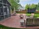 Spacious backyard featuring a patio, seating, dining area, screened-in porch, a trampoline, and a well-maintained lawn at 13497 Dunes Dr, Carmel, IN 46032