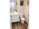 Clean and modern half bathroom featuring a floating vanity and updated fixtures at 13497 Dunes Dr, Carmel, IN 46032