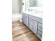 Bright bathroom featuring a double sink vanity with grey cabinets and modern fixtures, alongside a tiled shower and bath at 13497 Dunes Dr, Carmel, IN 46032