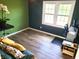 Bright bedroom with hardwood floors, large window, and green painted walls at 13497 Dunes Dr, Carmel, IN 46032