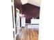 Bedroom entrance revealing hardwood floors, plum walls, and white dressers, with a glimpse into the ensuite bathroom at 13497 Dunes Dr, Carmel, IN 46032