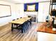 Dining room with a large table, blue accent wall, and built-in storage at 13497 Dunes Dr, Carmel, IN 46032
