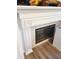 Close up of a white fireplace with tile surround and decorative mantle at 13497 Dunes Dr, Carmel, IN 46032
