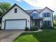 Beautiful two-story home with a two-car garage, well-maintained lawn, and classic architectural details at 13497 Dunes Dr, Carmel, IN 46032