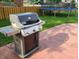 Modern grill on a patio, perfect for outdoor cooking and entertaining, with a trampoline visible in the background at 13497 Dunes Dr, Carmel, IN 46032
