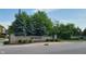 Stone entrance to a community with mature trees, landscaping and signage at 13497 Dunes Dr, Carmel, IN 46032