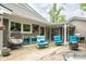 Spacious backyard patio area with outdoor seating, a grill, and lush landscaping at 140 Meridian Hills Blvd, Indianapolis, IN 46260