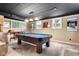 Basement featuring a pool table, bar area, and comfortable seating, with plenty of natural light at 140 Meridian Hills Blvd, Indianapolis, IN 46260