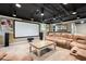 Finished basement boasting a large movie screen, wet bar, comfortable seating and neutral carpet at 140 Meridian Hills Blvd, Indianapolis, IN 46260