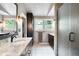 Bathroom featuring dual vanities, granite counters, tile flooring, and a walk-in shower at 140 Meridian Hills Blvd, Indianapolis, IN 46260