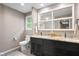Elegant bathroom with a dual vanity, granite countertops, a large mirror, and a toilet at 140 Meridian Hills Blvd, Indianapolis, IN 46260