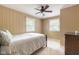 Bright bedroom features neutral walls, carpet and a ceiling fan, with a bed and two windows at 140 Meridian Hills Blvd, Indianapolis, IN 46260