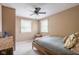 Cozy bedroom with neutral walls, carpet and a ceiling fan, featuring a bed and two windows at 140 Meridian Hills Blvd, Indianapolis, IN 46260
