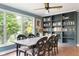 Inviting dining room boasts a large window and custom built-in bookshelves at 140 Meridian Hills Blvd, Indianapolis, IN 46260