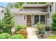 Inviting entryway with stylish front door, pretty landscaping, and modern security features at 140 Meridian Hills Blvd, Indianapolis, IN 46260