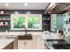 Close-up of modern kitchen sink, backsplash, and stainless steel appliances at 140 Meridian Hills Blvd, Indianapolis, IN 46260