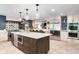 Spacious kitchen with stainless steel appliances, dark wood island, and breakfast bar seating at 140 Meridian Hills Blvd, Indianapolis, IN 46260