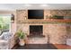 Charming living room showcasing a stone fireplace with a wooden mantel and hearth, creating a warm focal point at 140 Meridian Hills Blvd, Indianapolis, IN 46260