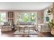 Elegant living room featuring a large window, hardwood floors, and comfortable seating, ideal for entertaining guests at 140 Meridian Hills Blvd, Indianapolis, IN 46260