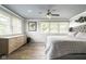 Bright main bedroom featuring lots of natural light, a ceiling fan, and hard wood floors at 140 Meridian Hills Blvd, Indianapolis, IN 46260