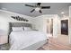 Bright main bedroom featuring lots of natural light, a ceiling fan, and hard wood floors at 140 Meridian Hills Blvd, Indianapolis, IN 46260