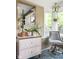 Sunlit office nook with a decorative chest of drawers and a desk chair, offering a tranquil spot for working or studying at 140 Meridian Hills Blvd, Indianapolis, IN 46260
