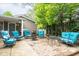 Backyard patio featuring a seating area with a grill, fire pit, and lush landscaping at 140 Meridian Hills Blvd, Indianapolis, IN 46260