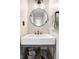 Modern powder room features a unique vessel sink, round mirror, and stylish lighting at 140 Meridian Hills Blvd, Indianapolis, IN 46260