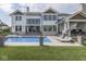 Backyard with a refreshing pool and a covered outdoor seating area that is perfect for relaxing and entertaining guests at 14464 Gainesway Cir, Fishers, IN 46040