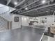 Finished basement with staircase, ping pong table, and neutral colored sectional couch at 14464 Gainesway Cir, Fishers, IN 46040