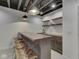Basement bar with wooden countertop, bar stools, shelving, and pendant lighting at 14464 Gainesway Cir, Fishers, IN 46040