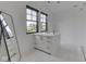 Modern bathroom features a white vanity with marble countertop and two black frame windows for natural light at 14464 Gainesway Cir, Fishers, IN 46040
