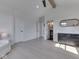 Spacious bedroom with a black dresser, hardwood floors, white trim, and a doorway to the bathroom at 14464 Gainesway Cir, Fishers, IN 46040