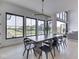 Bright dining area with large windows offering picturesque views and contemporary light fixture at 14464 Gainesway Cir, Fishers, IN 46040