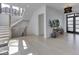 Modern foyer featuring light hardwood floors, staircase, and direct access to the front door at 14464 Gainesway Cir, Fishers, IN 46040