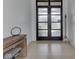 Foyer features a modern front door, wooden bench, a mirror, and light hardwood floors at 14464 Gainesway Cir, Fishers, IN 46040
