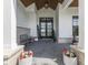 Welcoming front porch with stone base columns, a dark front door, and decorative plants at 14464 Gainesway Cir, Fishers, IN 46040