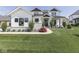 Charming two-story home boasting a manicured lawn, stone accents, and tasteful landscaping elements at 14464 Gainesway Cir, Fishers, IN 46040