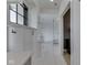 A hallway features white cabinets and black-trimmed windows leading to the ensuite bathroom at 14464 Gainesway Cir, Fishers, IN 46040