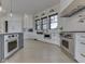 Modern kitchen with stainless steel appliances, white cabinets, and a stylish range hood at 14464 Gainesway Cir, Fishers, IN 46040