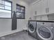 Functional laundry room featuring a sink, modern washer and dryer, and ample storage at 14464 Gainesway Cir, Fishers, IN 46040