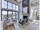 Spacious living room featuring a modern fireplace, soaring ceilings, large windows, and an open layout at 14464 Gainesway Cir, Fishers, IN 46040