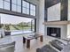 Bright living room with soaring ceilings, large windows, fireplace, and open access to the backyard pool at 14464 Gainesway Cir, Fishers, IN 46040