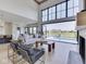 Elegant living room with a view of a pool, with large windows, providing ample natural light and stylish design at 14464 Gainesway Cir, Fishers, IN 46040