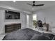 Modern main bedroom boasts a sleek black ceiling fan, spacious layout, and an adjacent bathroom for added convenience at 14464 Gainesway Cir, Fishers, IN 46040